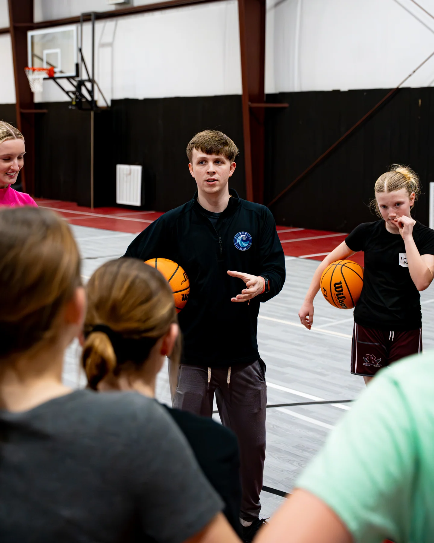 Coach Jake Tillery leading Surge Basketball players during a game